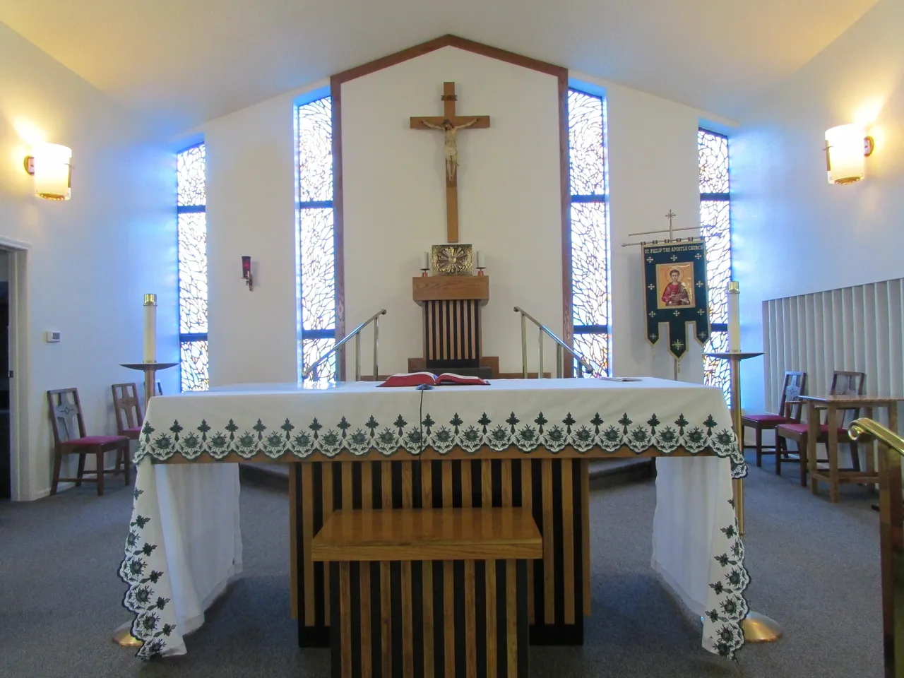 A church with a large cross on the altar.