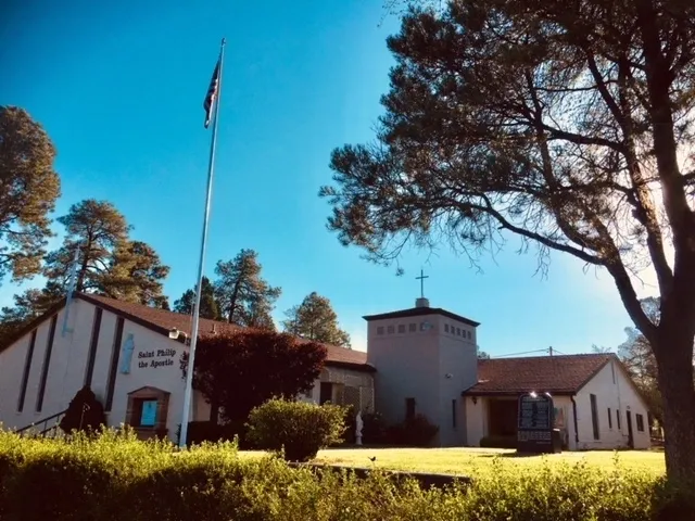 A church with trees and bushes in front of it