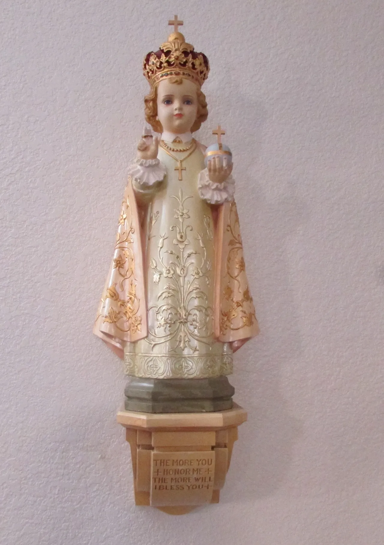 A statue of a child holding a candle.