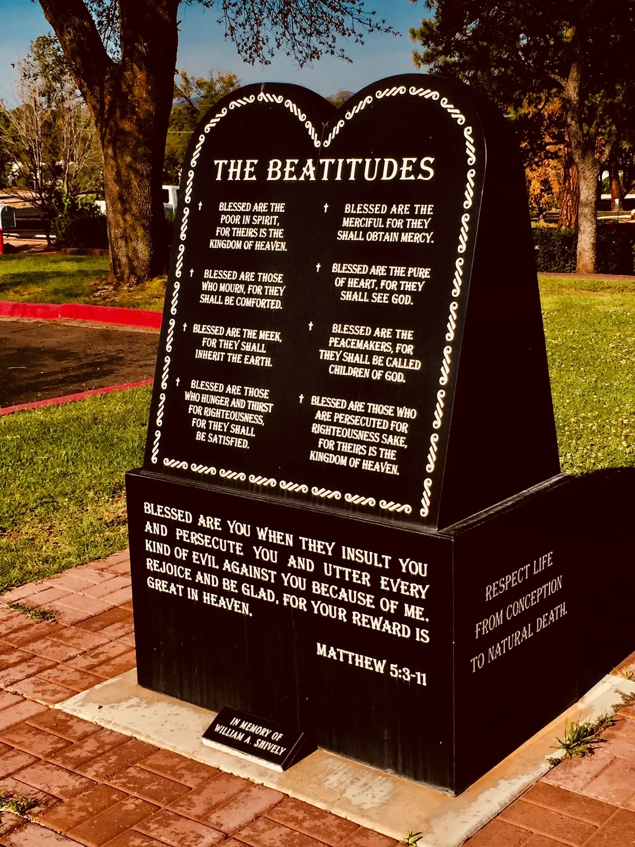 A monument with the words of the beatitudes on it.