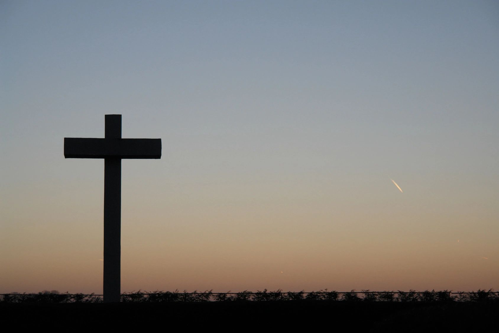 A cross is shown in the middle of a field.